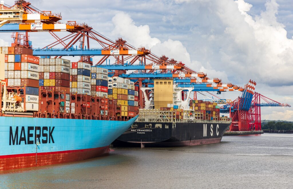 shipping to saudi Cargo containers being loaded onto a cargo ship at a port in Saudi Arabia.